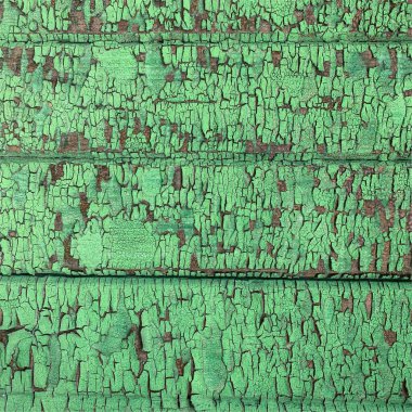 Yıpranmış boya desenli ahşap bir duvar.