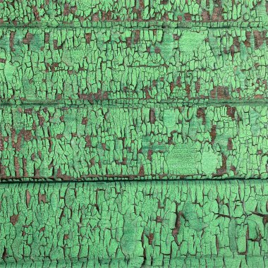 Yıpranmış boya desenli ahşap bir duvar.