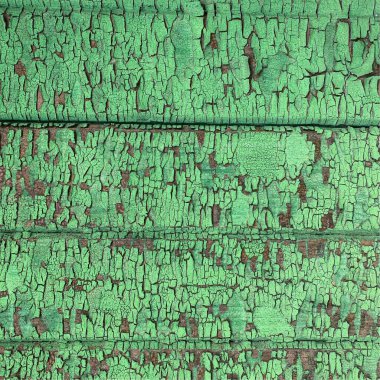 Yıpranmış boya desenli ahşap bir duvar.