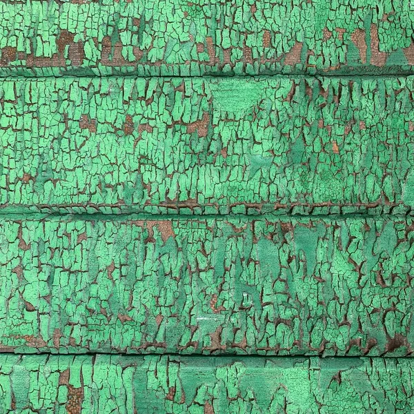 Yıpranmış boya desenli ahşap bir duvar.