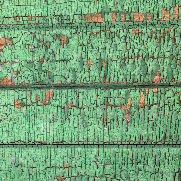 Yıpranmış boya desenli ahşap bir duvar.