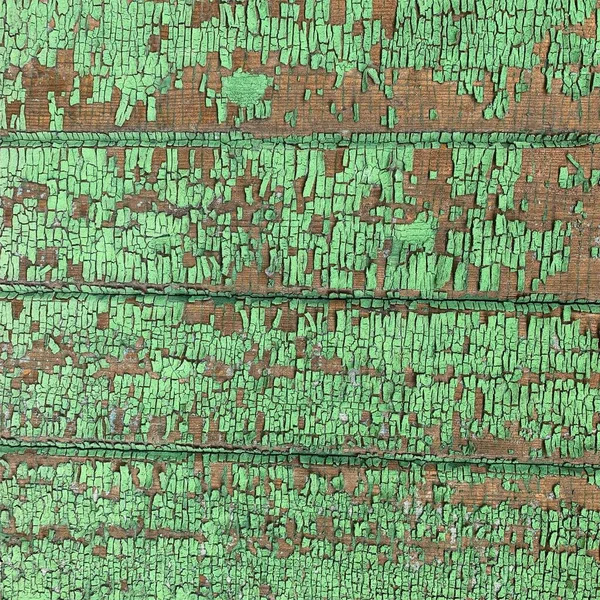 Yıpranmış boya desenli ahşap bir duvar.