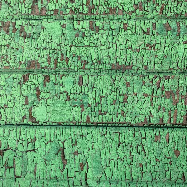 Yıpranmış boya desenli ahşap bir duvar.