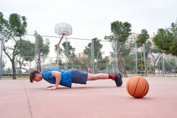 Oldalnézet Egy Sportos Fiatal Férfi Fekvőtámaszt Csinál Kosárlabda Edzés Szabadtéri — Stock Fotó
