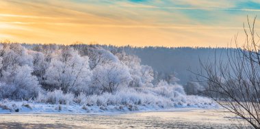 Winter sunset view of the San river and snow-covered trees