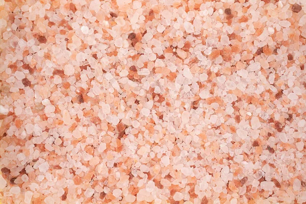 Pink himalayan salt background. Close up. Himalayan salt scattered on a table. pink salt cristalize background