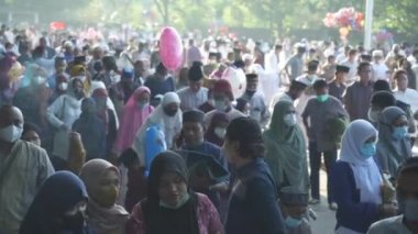 Bali, Indonesia - May 2 2022: Muslims Gather Celebrate Eid al-Fitr Salah Praying in a Park in Denpasar