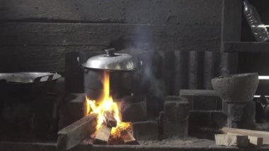 Cooking with Big Pot Pan on Fire Woods in Traditional Kitchen
