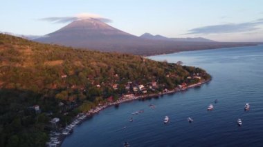 Aerial Drone Lenticular Clouds Morning Sunrise on Mount Agung Volcano and Jemeluk Bay Amed Beach Karangasem East Bali Indonesia