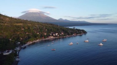 Aerial Drone Lenticular Clouds Morning Sunrise on Mount Agung Volcano and Jemeluk Bay Amed Beach Karangasem East Bali Indonesia