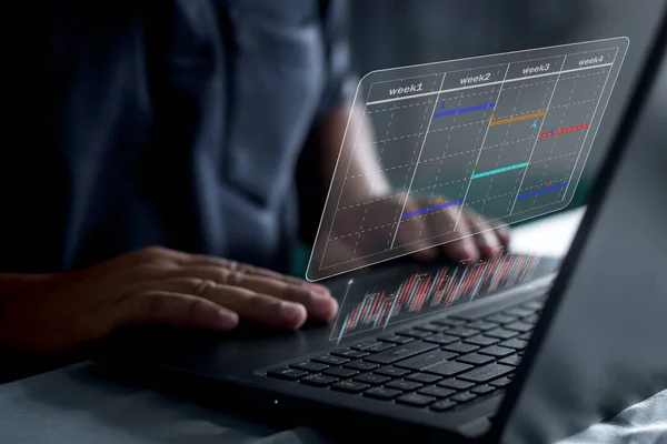 Businessman milestone plan project management updating gantt chart, business schedule virtual screen of laptop computer
