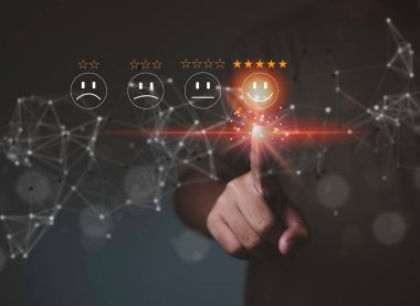 Customer review satisfaction feedback survey concept, User give rating to service experience on online,finger pressing smiley face emoticon on virtual touch screen. Customer service evaluation concept