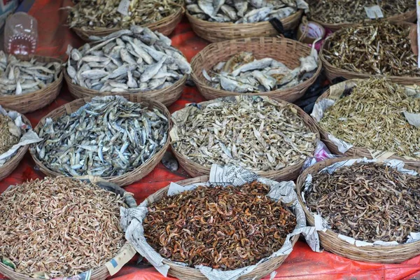 Selective focus on dry fish in wooden container basket for sale in indian fish market