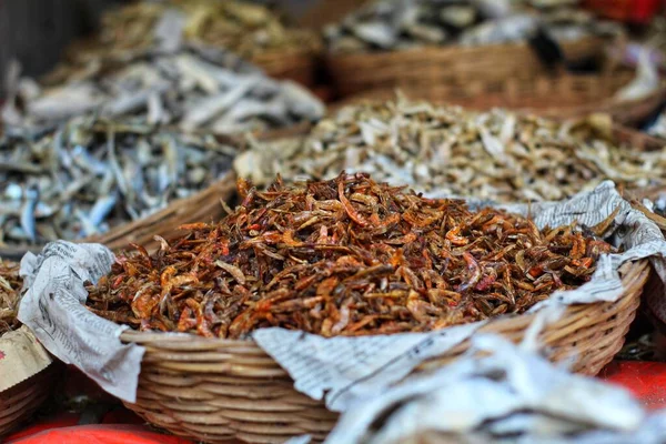 Selective focus on dry fish in wooden container basket for sale in indian fish market