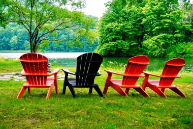 Black and red adirondack chairs near Abbott Lake in the Peaks of Otter area of the Blue Ridge Parkway in Virginia. Relax and enjoy the views. 