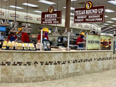 Daytona Beach, Florida: Buc-ee's convenience store and gas station. Food counter with fresh  BBQ, Texas Round Up, Brisket, Sausage, Turkey, Pulled Pork, Sweets, Fudge, Dipin' Dots, and Fudge.  clipart