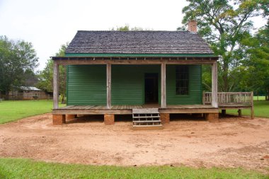 Plains, Georgia: Jimmy Carter National Historic Site. Rachel and Jack Clark's tenant house near Carter's boyhood home and farm. Exterior of green home with front porch and dirt yard.