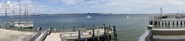 Charleston, South Carolina: Panoramic view of Charleston harbor from the National Park Service ferry port at Liberty Square to Fort Sumpter, Charleston Maritime Center, Arthur Ravenel Jr Bridge. clipart