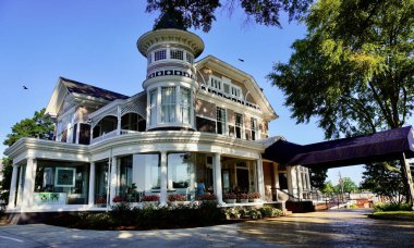 Anniston, Alabama: Hotel Finial, an upscale boutique hotel in a historic Victorian style mansion. Best Western Premier Collection. Exterior with porches, awning, entrance and tower. 