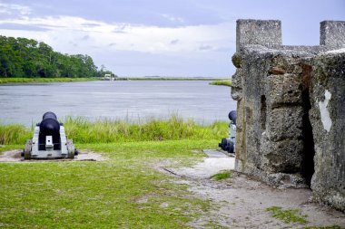 Fort Frederica National Monument, Georgia. Archaeological remnants of fort magazine built by James Oglethorpe to protect the southern boundary of the British colonies from Spanish. River and cannon.