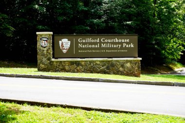 Greensboro, North Carolina: Sign for Guilford Courthouse National Military Park. The Battle of Guilford Court House was on March 15, 1781, during the American Revolutionary War. NPS arrowhead. clipart