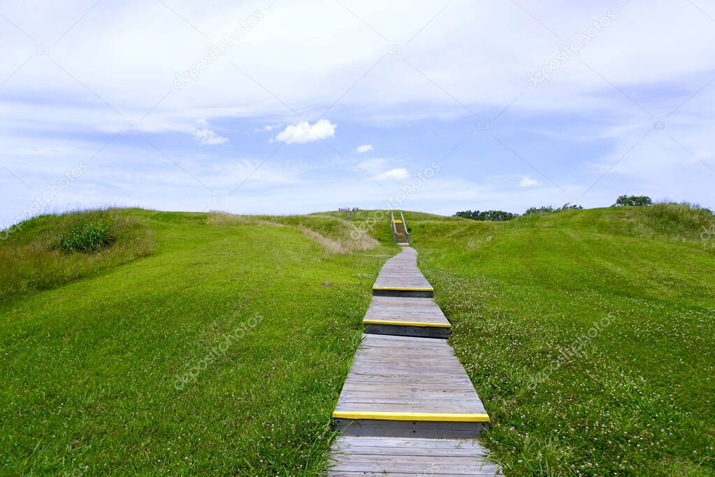Poverty Point World Heritage Site in Louisiana is a prehistoric monumental earthworks site constructed by the Poverty Point culture. Boardwalk stairs climbing the largest earthen mound - Mound A. 