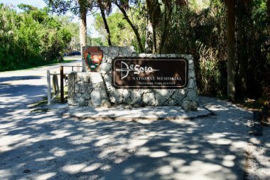Sign at De Soto National Memorial commemorates Hernando de Soto's landing and the first extensive European exploration of southern United States. Entrance sign. Florida.  clipart
