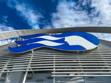 Emerald Princess Cruise ship. Princess cruise line's logo on the birdcage funnel. Princess Cruises Seawitch Logo with wave pattern and sea witch face.  clipart