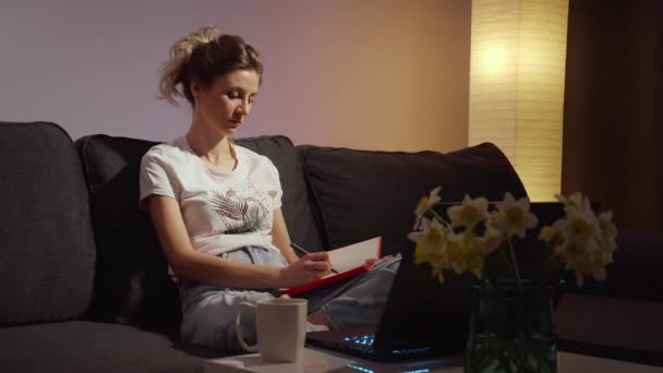 Young Woman Learning Online Class Night Late Makes Note Laptop — Stock Video