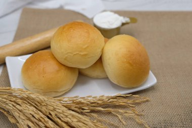 Fresh fragrant bread and bun on the table with copy space. Food concept