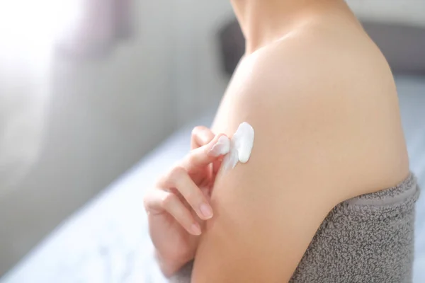 Asia woman applying natural cream, Woman moisturizing her arm with cosmetic cream, Spa and Manicure concept.