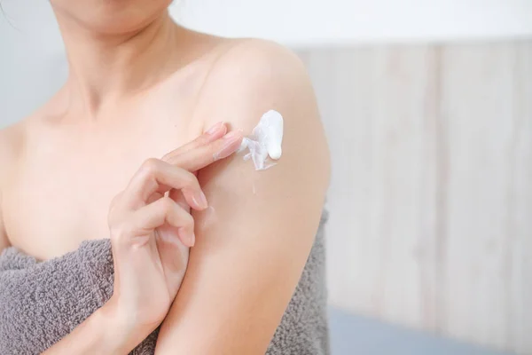 Asia woman applying natural cream, Woman moisturizing her arm with cosmetic cream, Spa and Manicure concept.