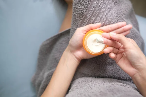 Asia woman applying natural cream, Woman moisturizing her hand with cosmetic cream, Spa and Manicure concept. Top view.