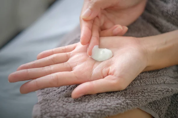 Asia woman applying natural cream, Woman moisturizing her hand with cosmetic cream, Spa and Manicure concept.