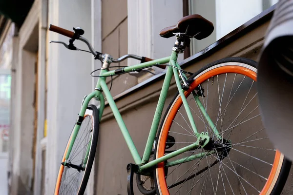 A city bike parked against the wall of a cafe in the city, Cycling to work, a stylish bike in an urban environment, the concept of ecological transport.