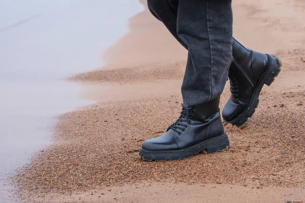 Feet Black Leather Rough Boots Black Fashionable Denim Pants Standing — Stock Photo, Image