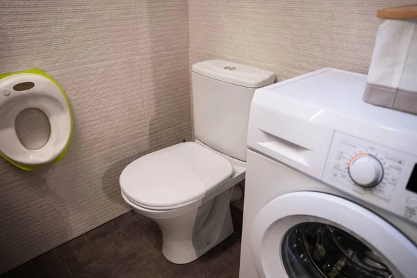 A mobília da casa de banho, banheiro e máquina de lavar roupa, um assento para os pequenos. — Fotografia de Stock