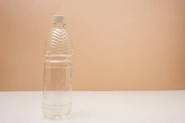 Empty plastic bottle with screw cap on pink background — Photo