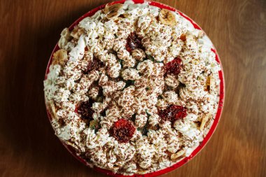 Delicious beautiful cake decorated with cream and banana slices on the table