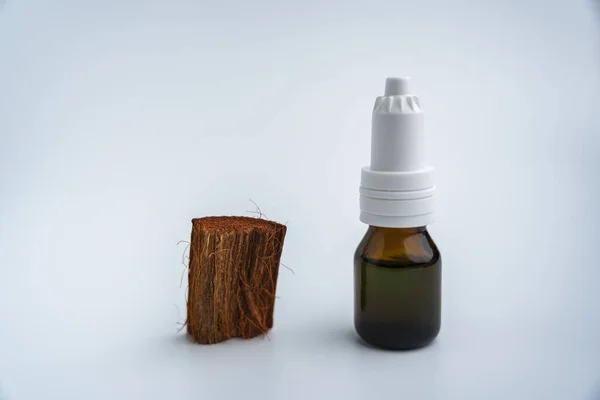 Beyaz arka planda bir şişe aromatik yağ. İçinde ilaç olan bir şişe.