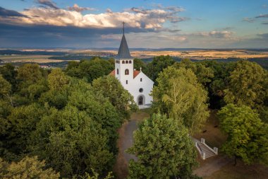Church with a lookout tower at sunset photo from a drone Czech Repubblic