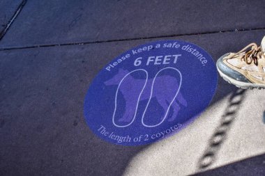 Grand Canyon Ulusal Parkı, Arizona, ABD - 22 Kasım 2021: Yerdeki Mavi İşaret Ziyaretçilere Bir Çakal ile Altı Ayaklı Karşılaştırma Otobüsünü Beklerken Sosyal Mesafeye Girmelerini Anımsatıyor