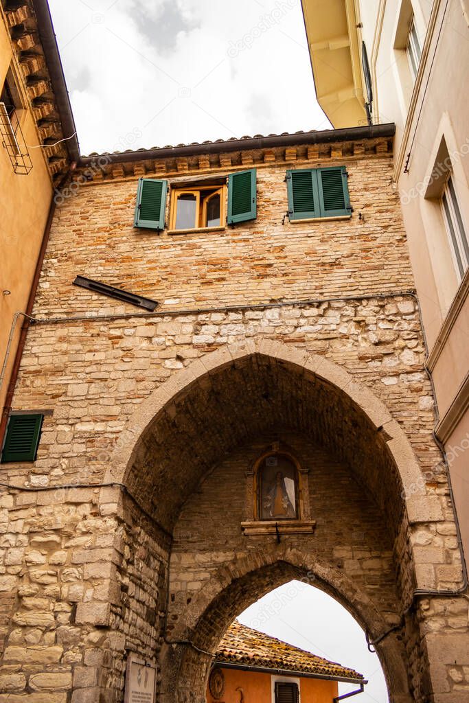 Gothic arch of the entrance door in the village of Sirolo, Marche - Italy