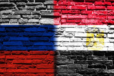 Background with the flag of Russia and Egypt on a brick wall