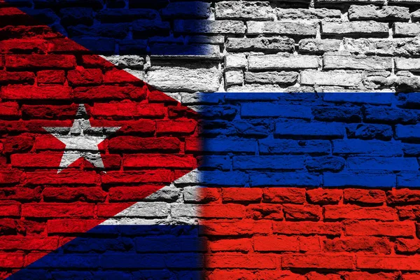 Background with the flag of Russia and Cuba on a brick wall