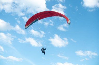 Mavi gökyüzünde paraşütçü uçuyor 