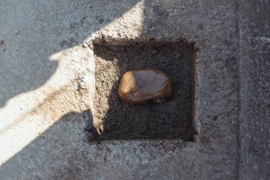 İlk taşı inşaat halindeki bir evin temelinde beton zemine karşı koymak.