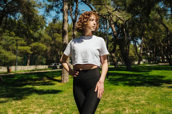 Young Curly Redhead Woman Wearing White Tees Black Leggings Looking — ストック写真