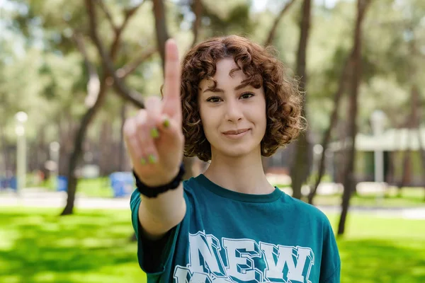 Young Redhead Woman Wearing Green Tee Showing Number One Finger — Foto Stock