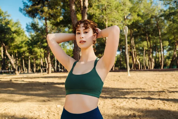 Young Redhead Woman Touching Hair Wearing Green Sports Bra Blue — Φωτογραφία Αρχείου